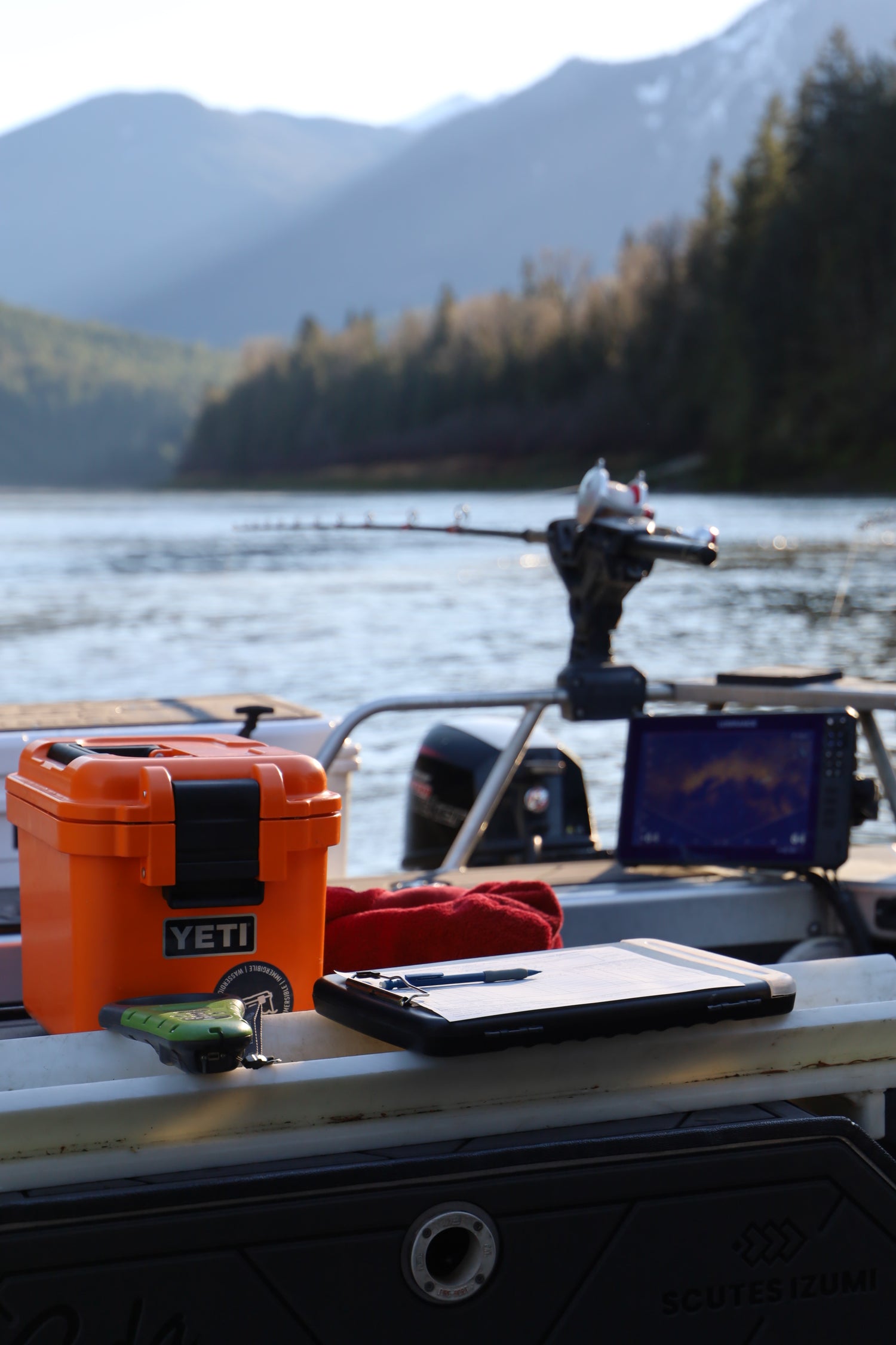 Orange toolbox on a metal cart with a mountainous landscape in the background